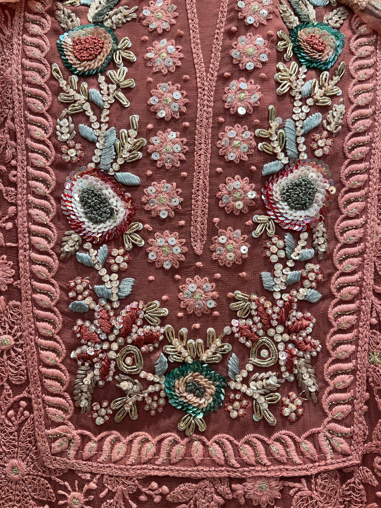 Elegance with this premium unstitched suit set, featuring a pure Georgette top adorned