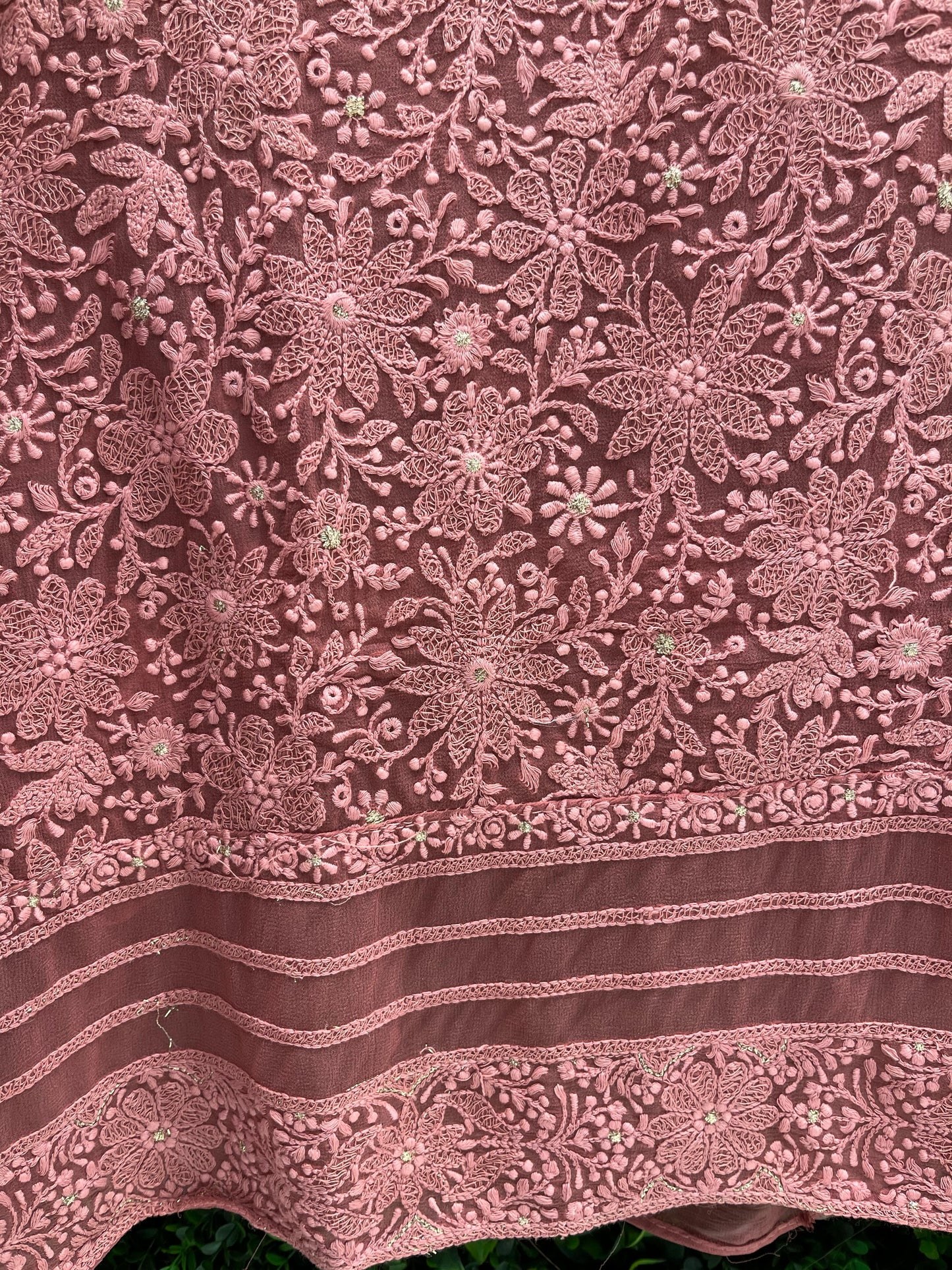 Elegance with this premium unstitched suit set, featuring a pure Georgette top adorned