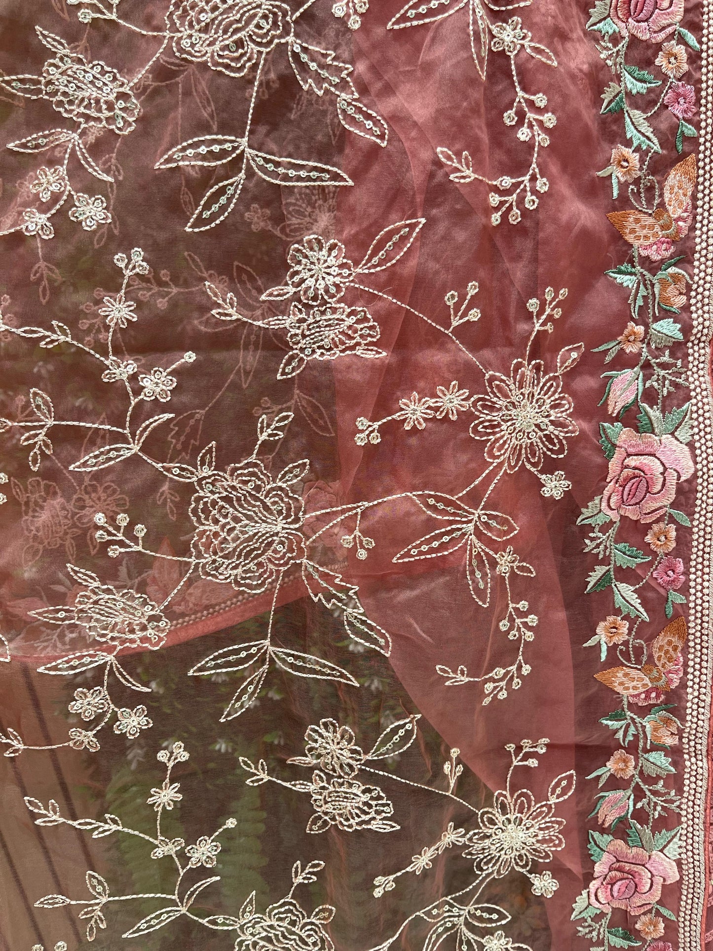 Elegance with this premium unstitched suit set, featuring a pure Georgette top adorned
