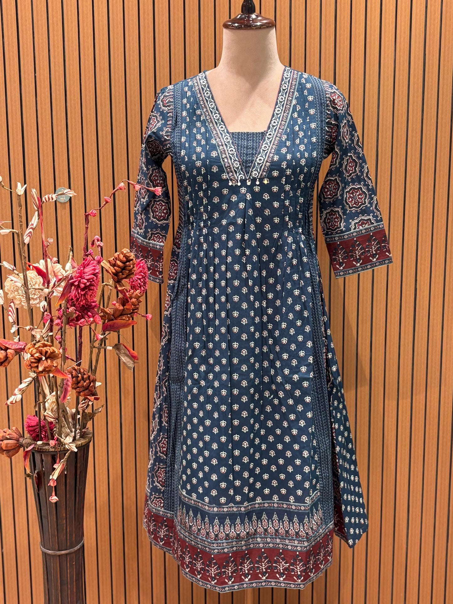 This trending ethnic suit features a navy blue base with intricate block prints