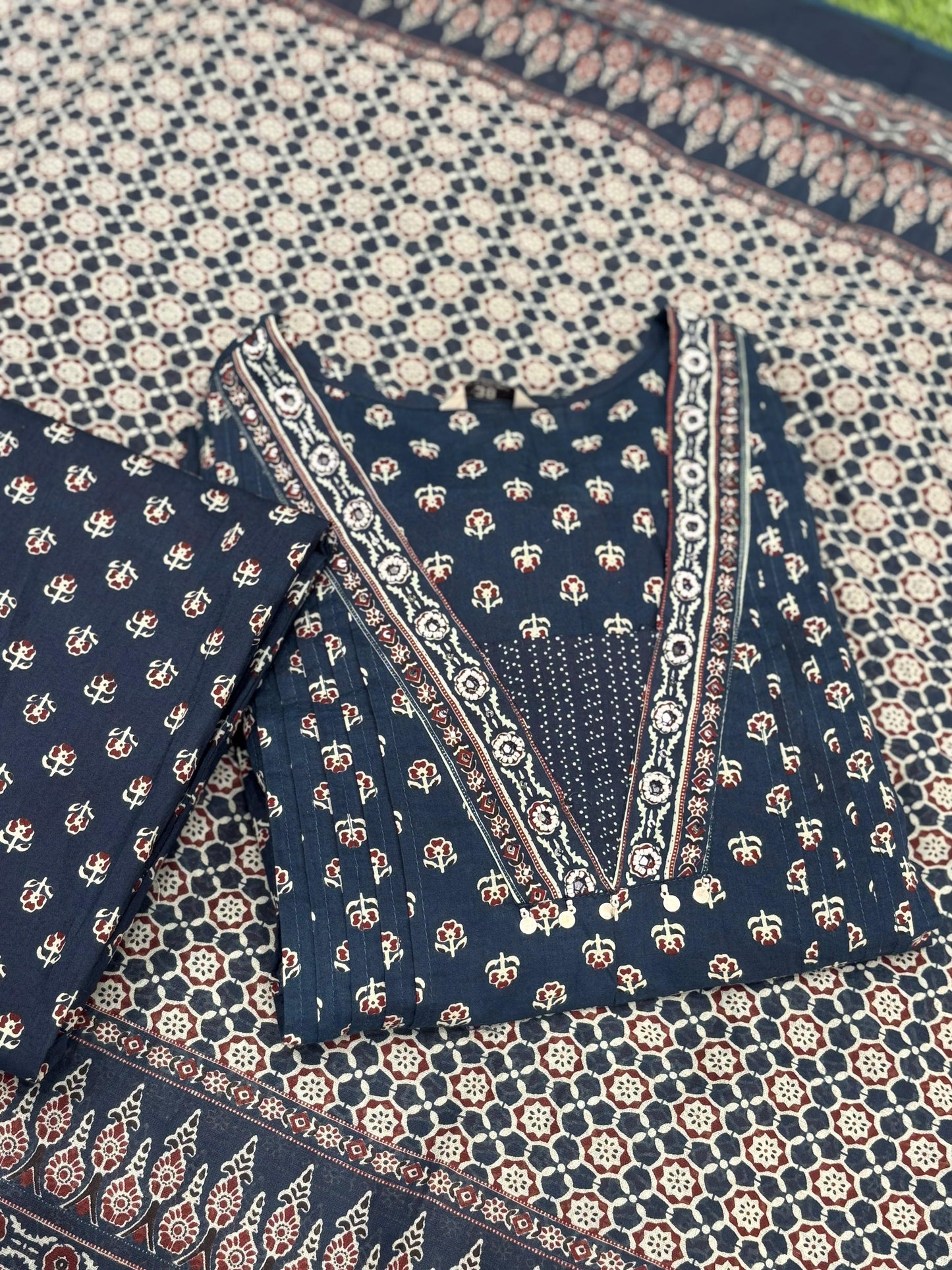 This trending ethnic suit features a navy blue base with intricate block prints