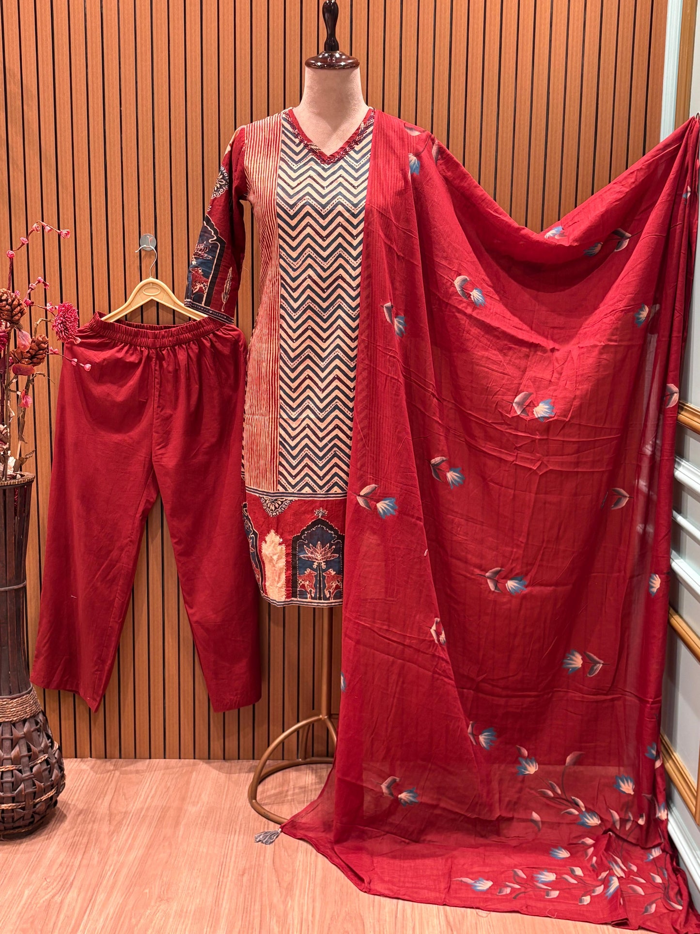 This vibrant red ethnic suit features a bold chevron-printed kurta