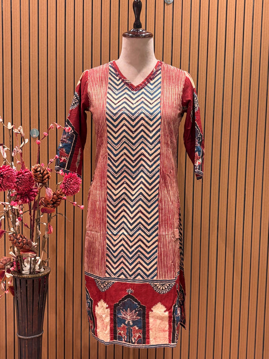 This vibrant red ethnic suit features a bold chevron-printed kurta