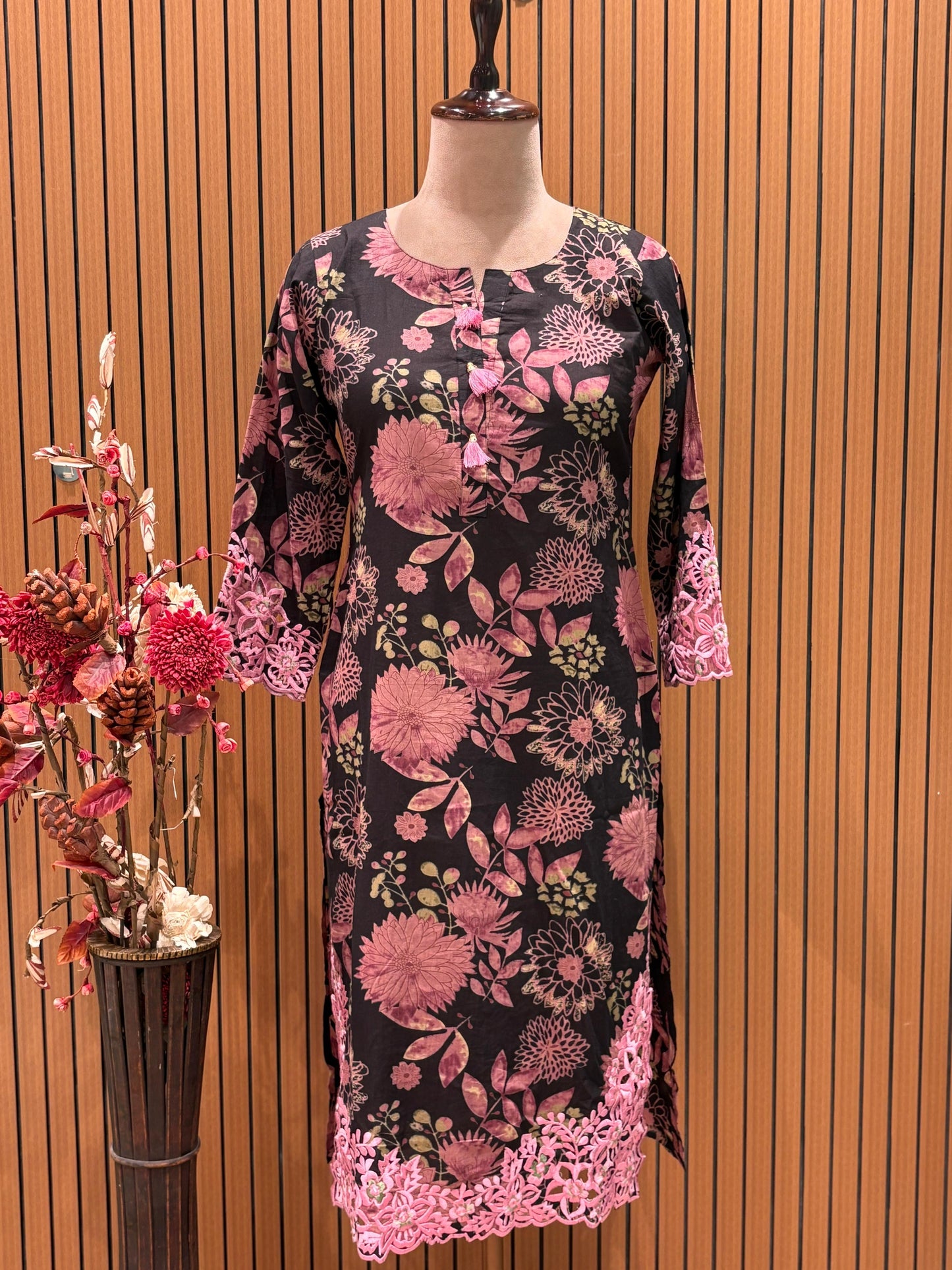 This elegant floral-printed suit features a deep brown base