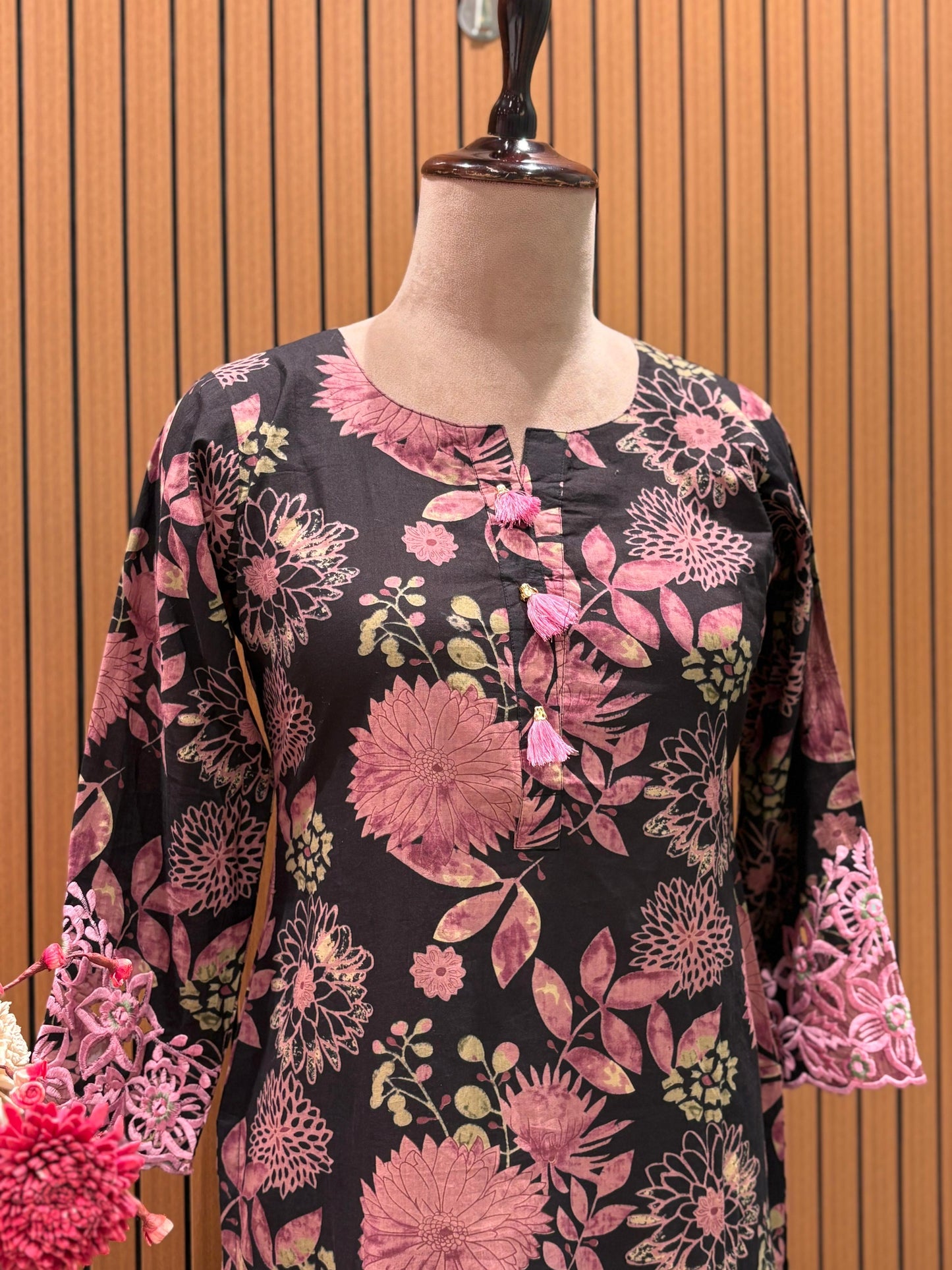This elegant floral-printed suit features a deep brown base