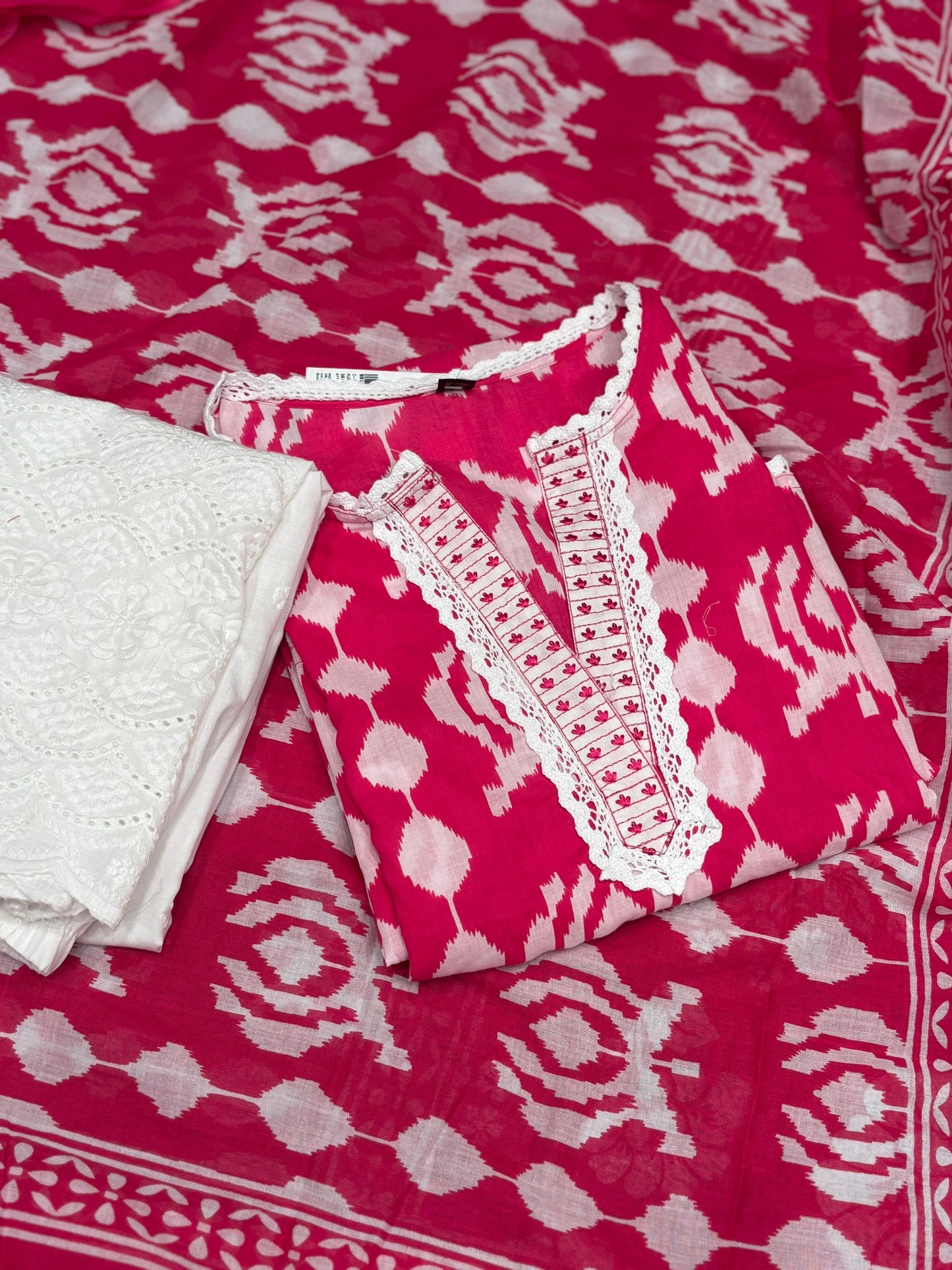 Vibrant pink and white ethnic suit set features a bold printed kurta