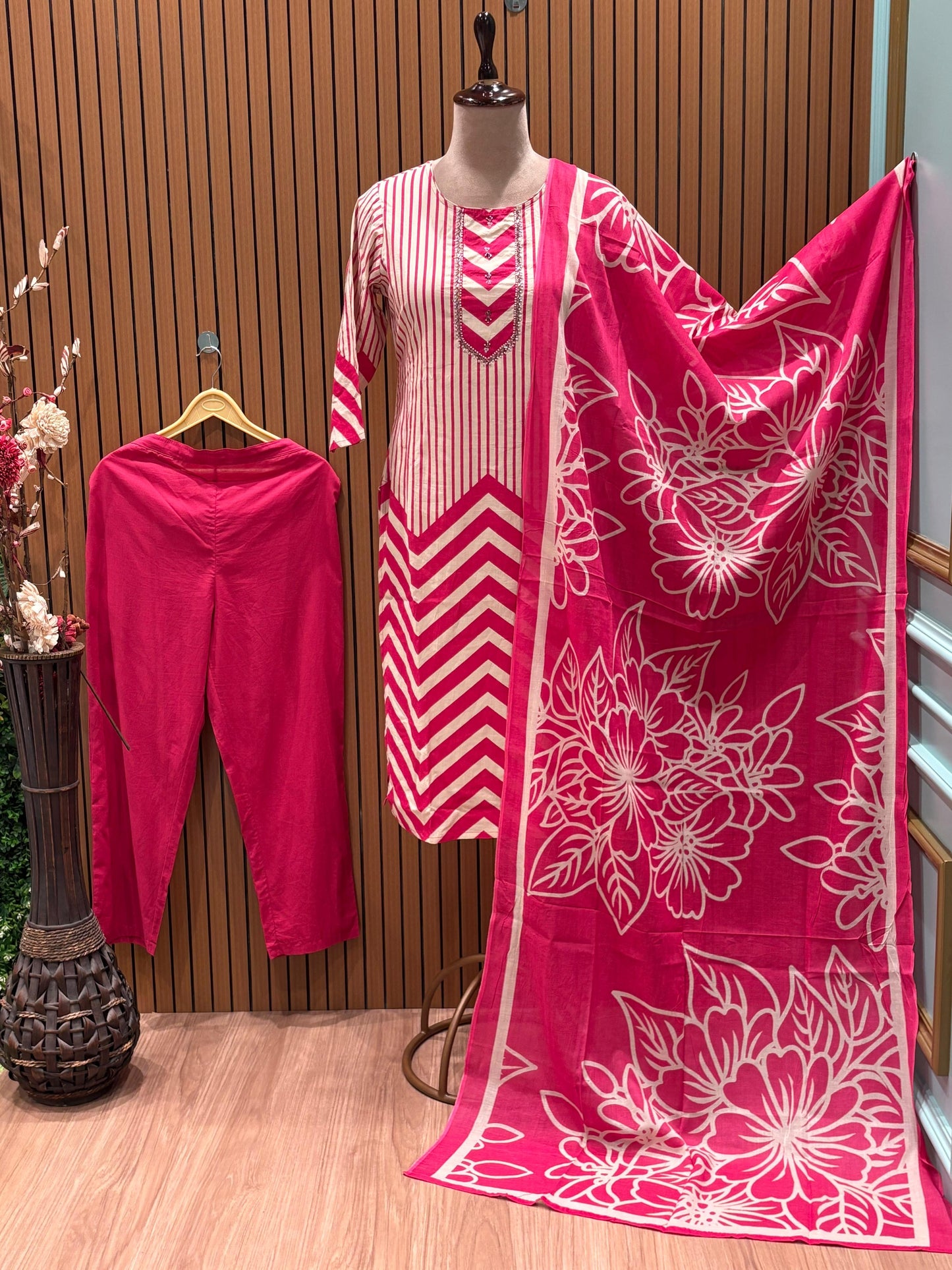 Vbrant pink and cream suit set features a stylish mix of vertical