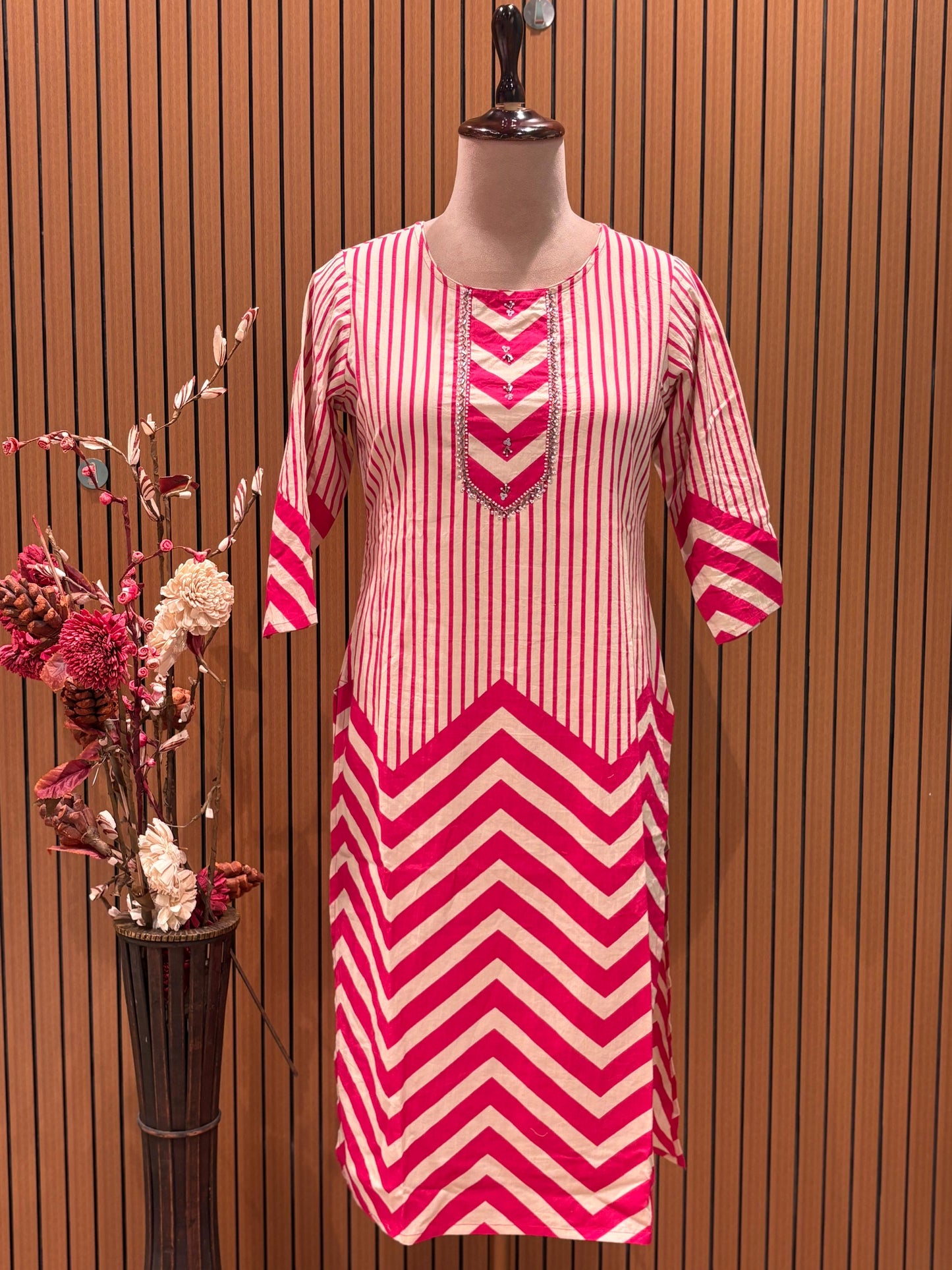 Vbrant pink and cream suit set features a stylish mix of vertical