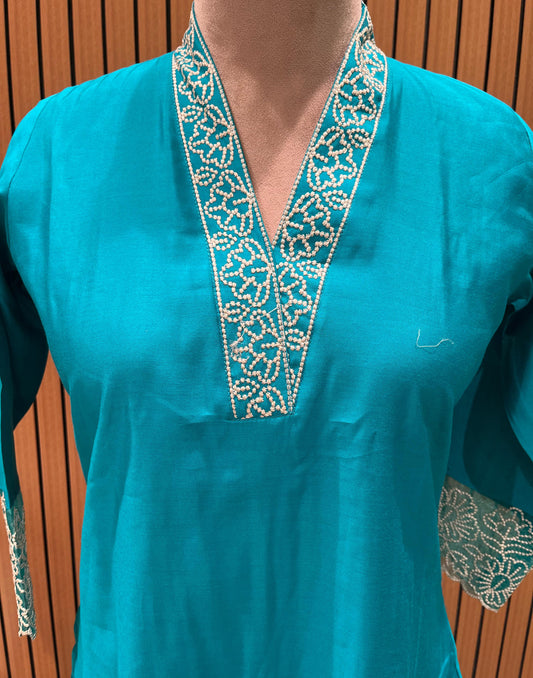 Stunning turquoise salwar suit features delicate white floral embroidery