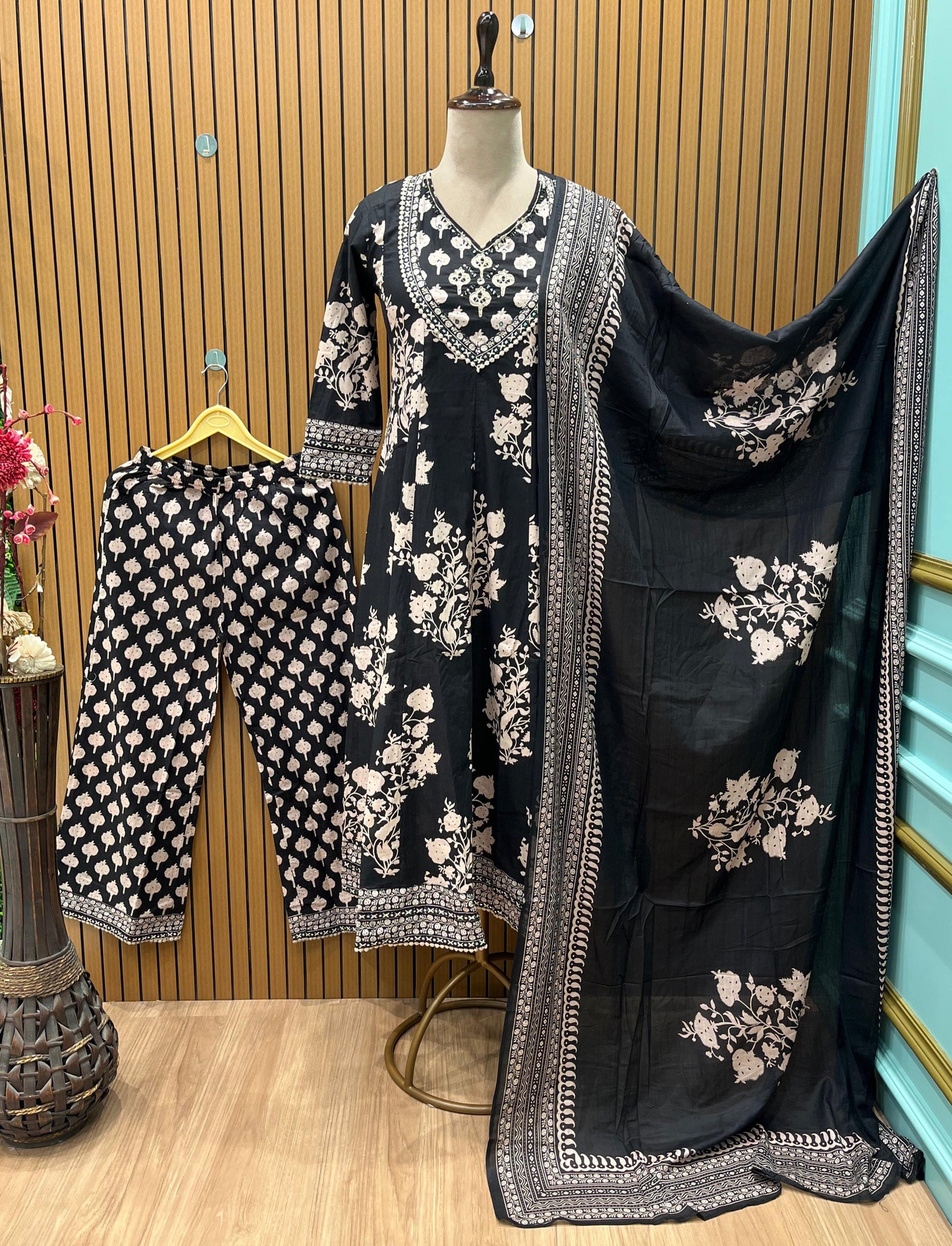 Black ethnic ensemble features elegant floral and vine prints