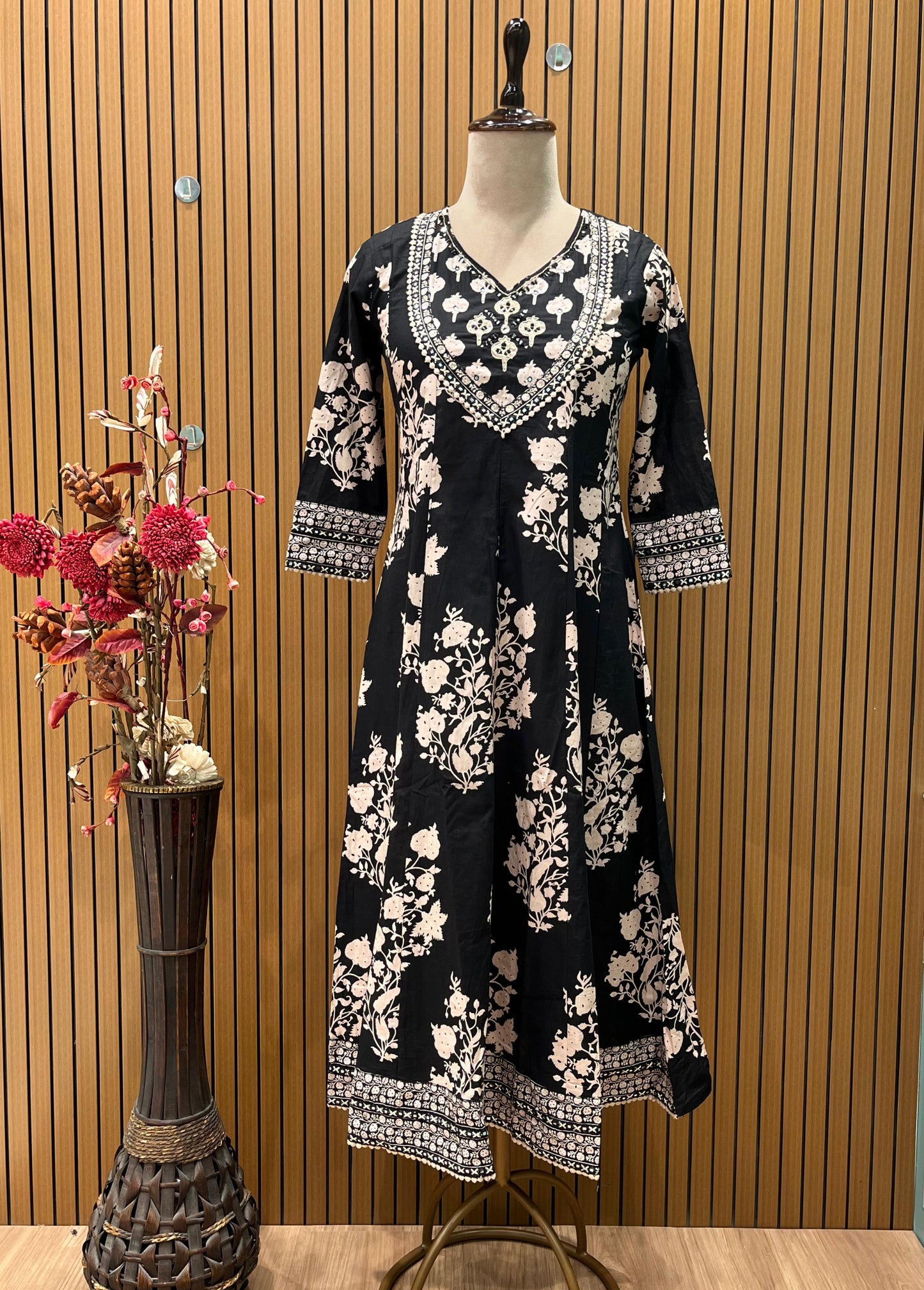 Black ethnic ensemble features elegant floral and vine prints