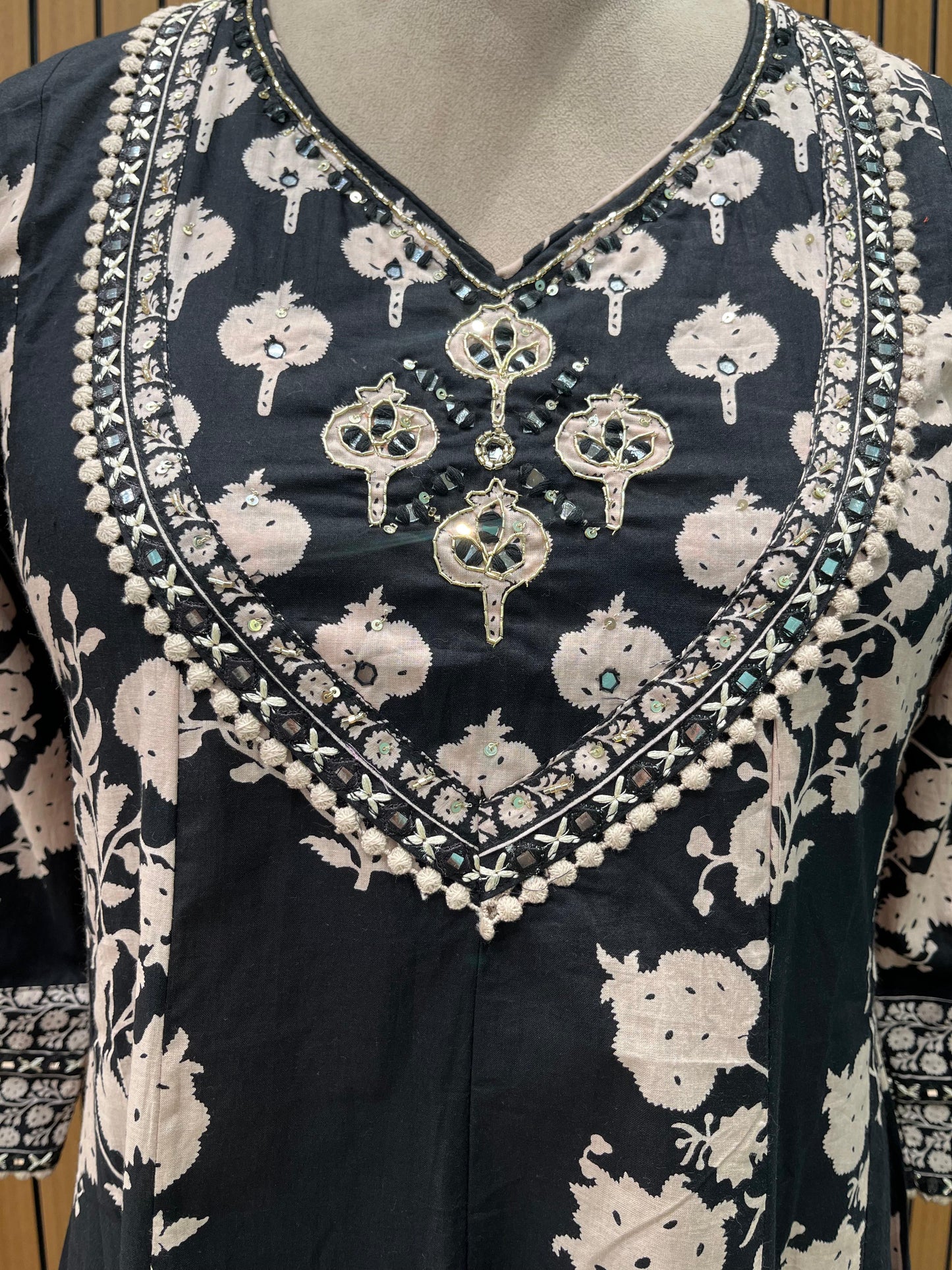 Black ethnic ensemble features elegant floral and vine prints