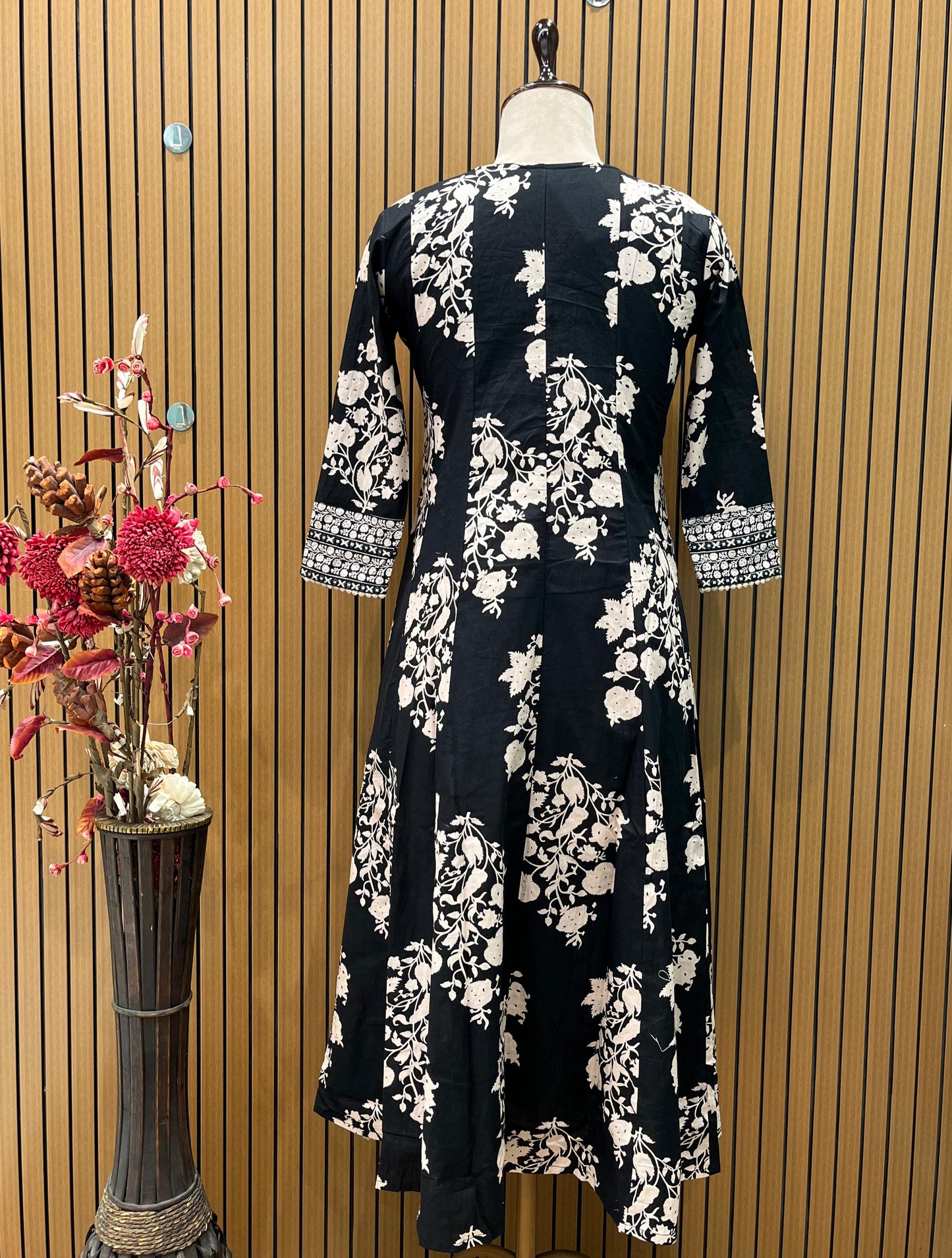 Black ethnic ensemble features elegant floral and vine prints