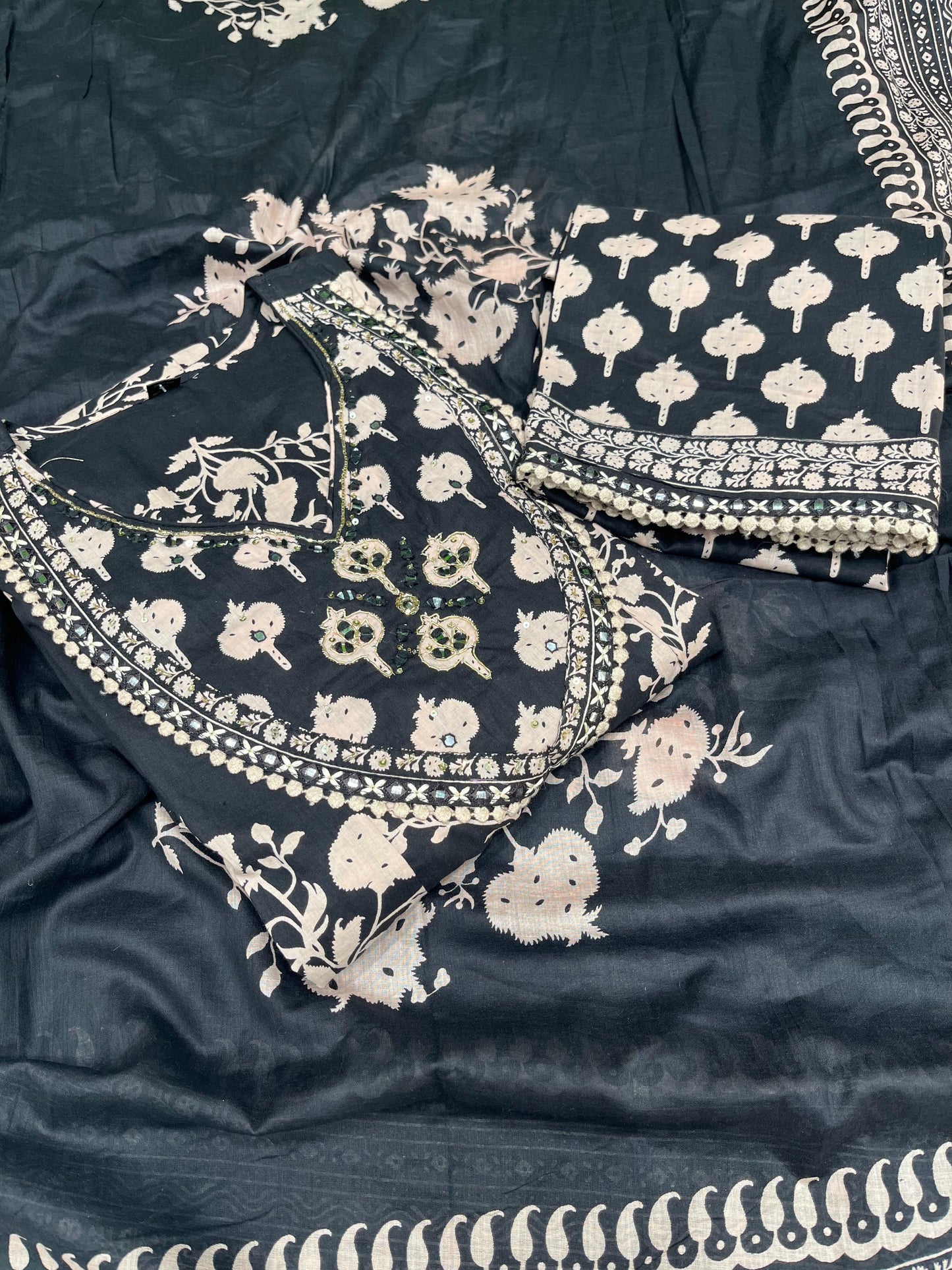 Black ethnic ensemble features elegant floral and vine prints