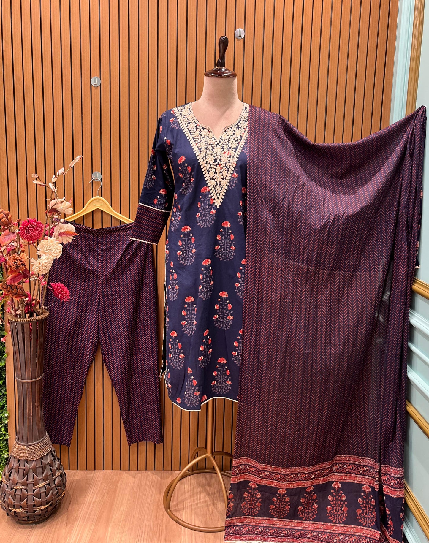 Elegant navy blue three-piece suit features floral embroidery on the neckline,