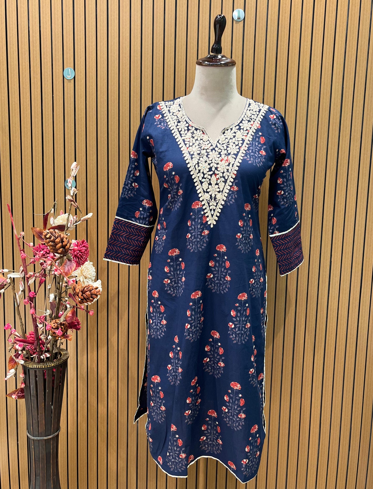 Elegant navy blue three-piece suit features floral embroidery on the neckline,