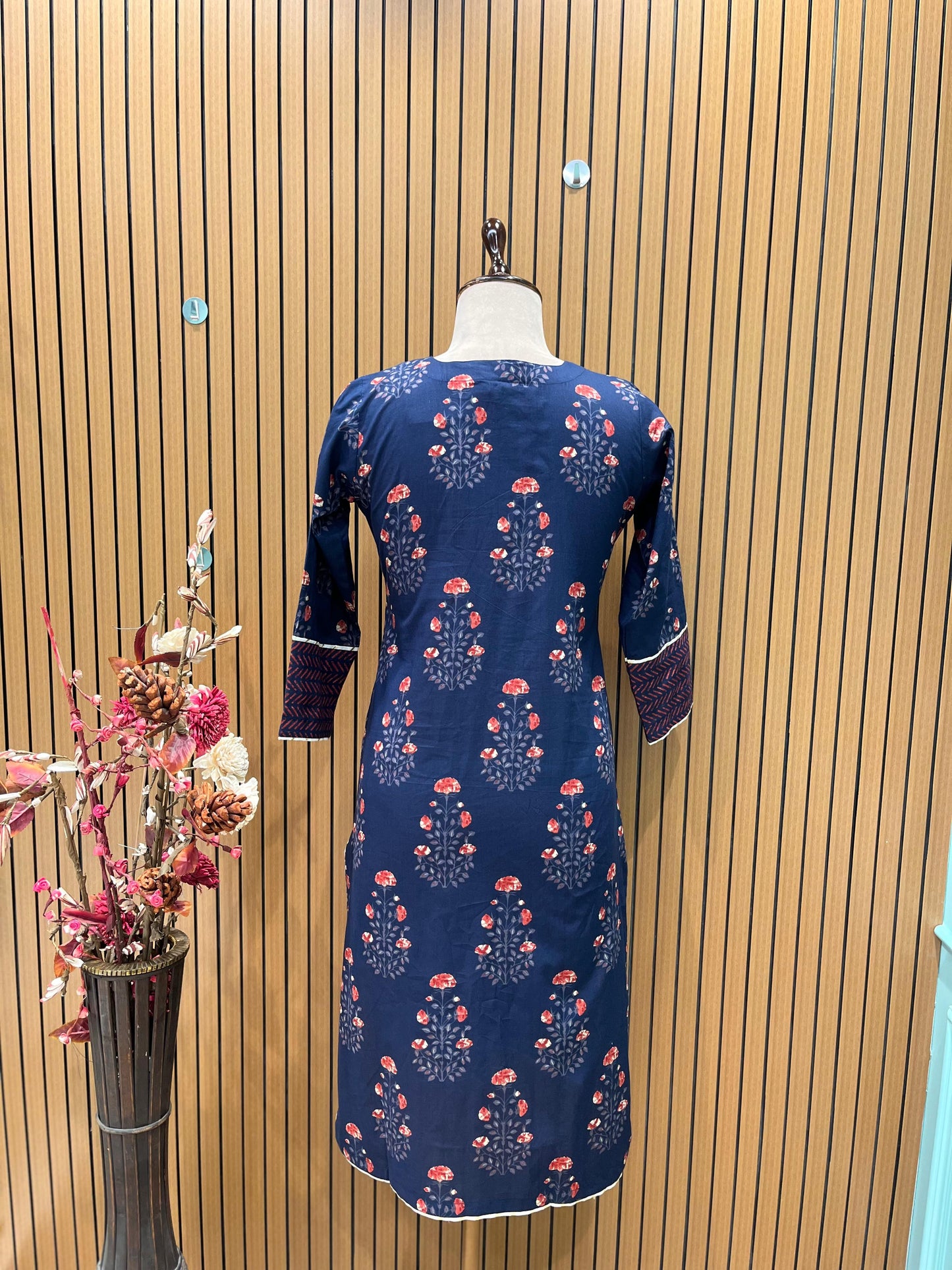 Elegant navy blue three-piece suit features floral embroidery on the neckline,