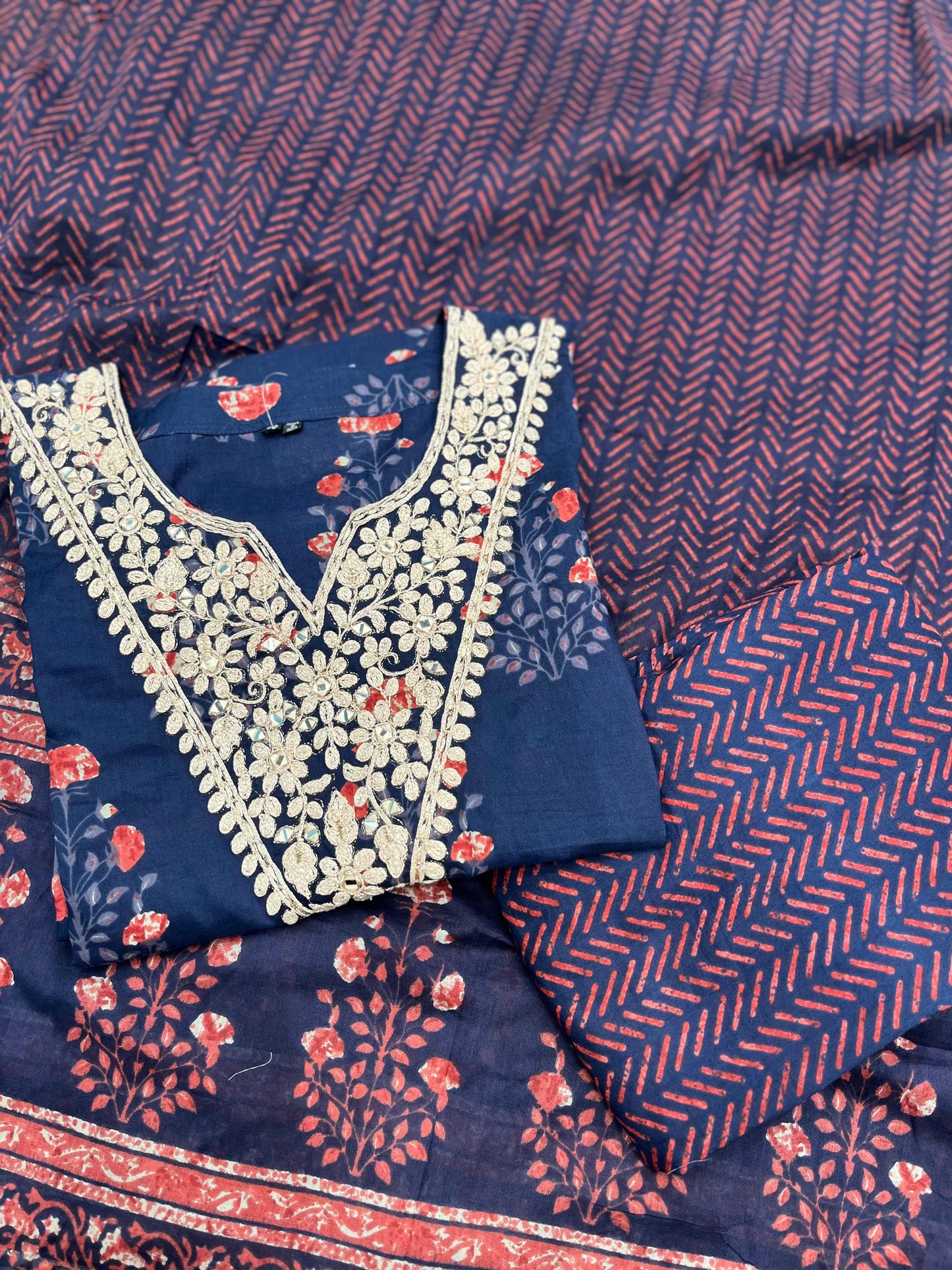 Elegant navy blue three-piece suit features floral embroidery on the neckline,