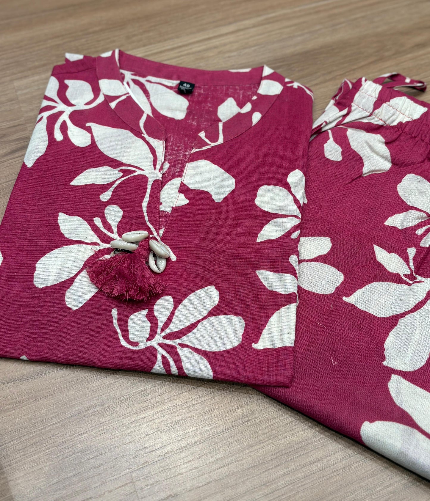 Vibrant magenta co-ord set features bold white floral prints