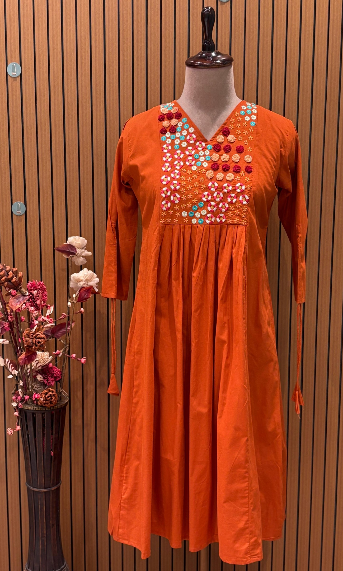 Brighten your wardrobe with this vibrant orange A-line kurti set