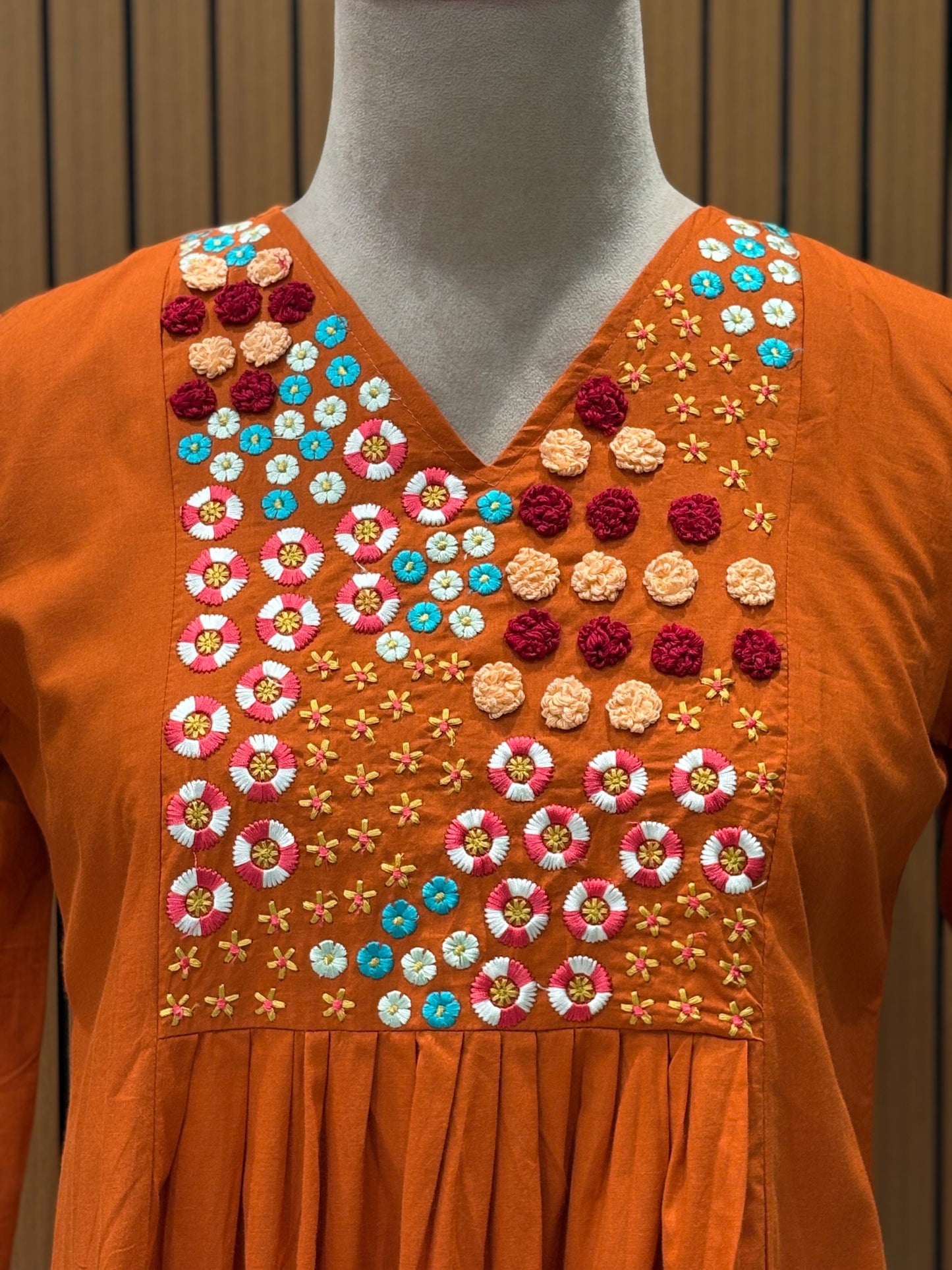 Brighten your wardrobe with this vibrant orange A-line kurti set