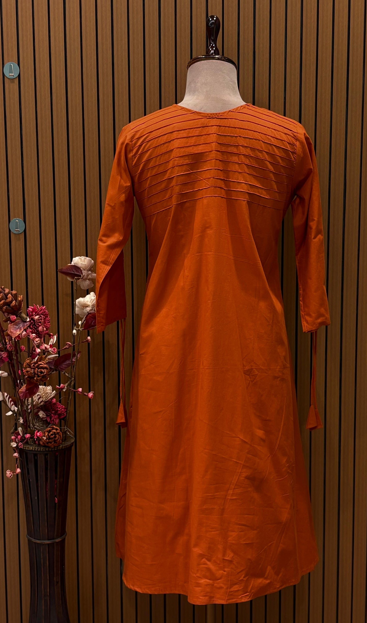 Brighten your wardrobe with this vibrant orange A-line kurti set