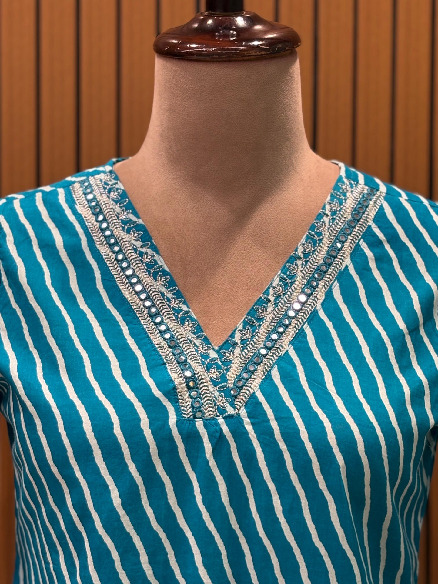 Make a statement in this vibrant turquoise kurti set