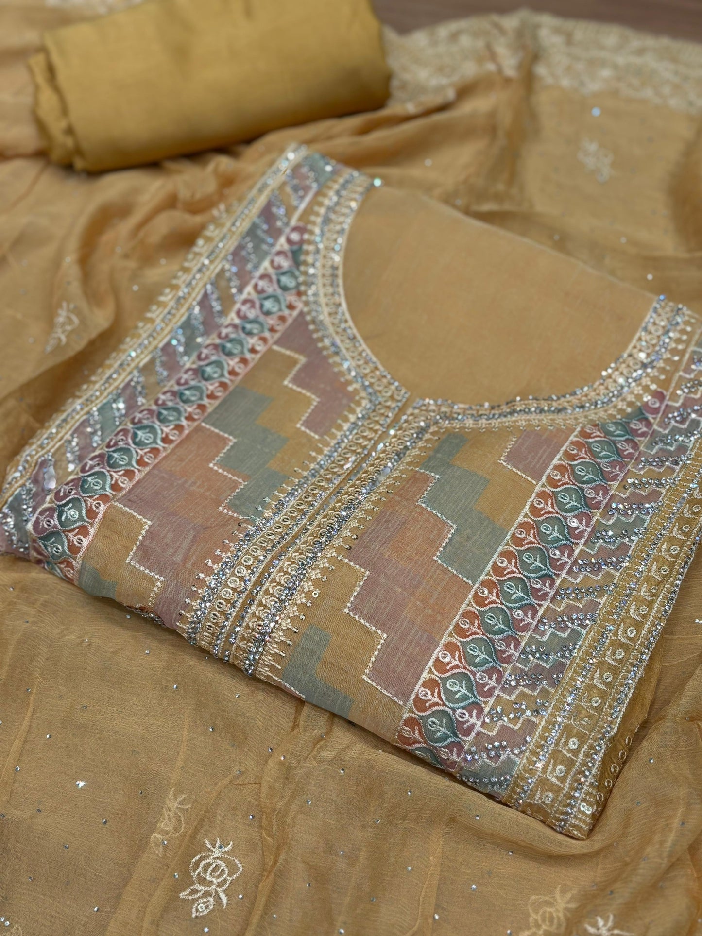 Presenting an elegant unstitched suit set in a soothing mustard-gold hue