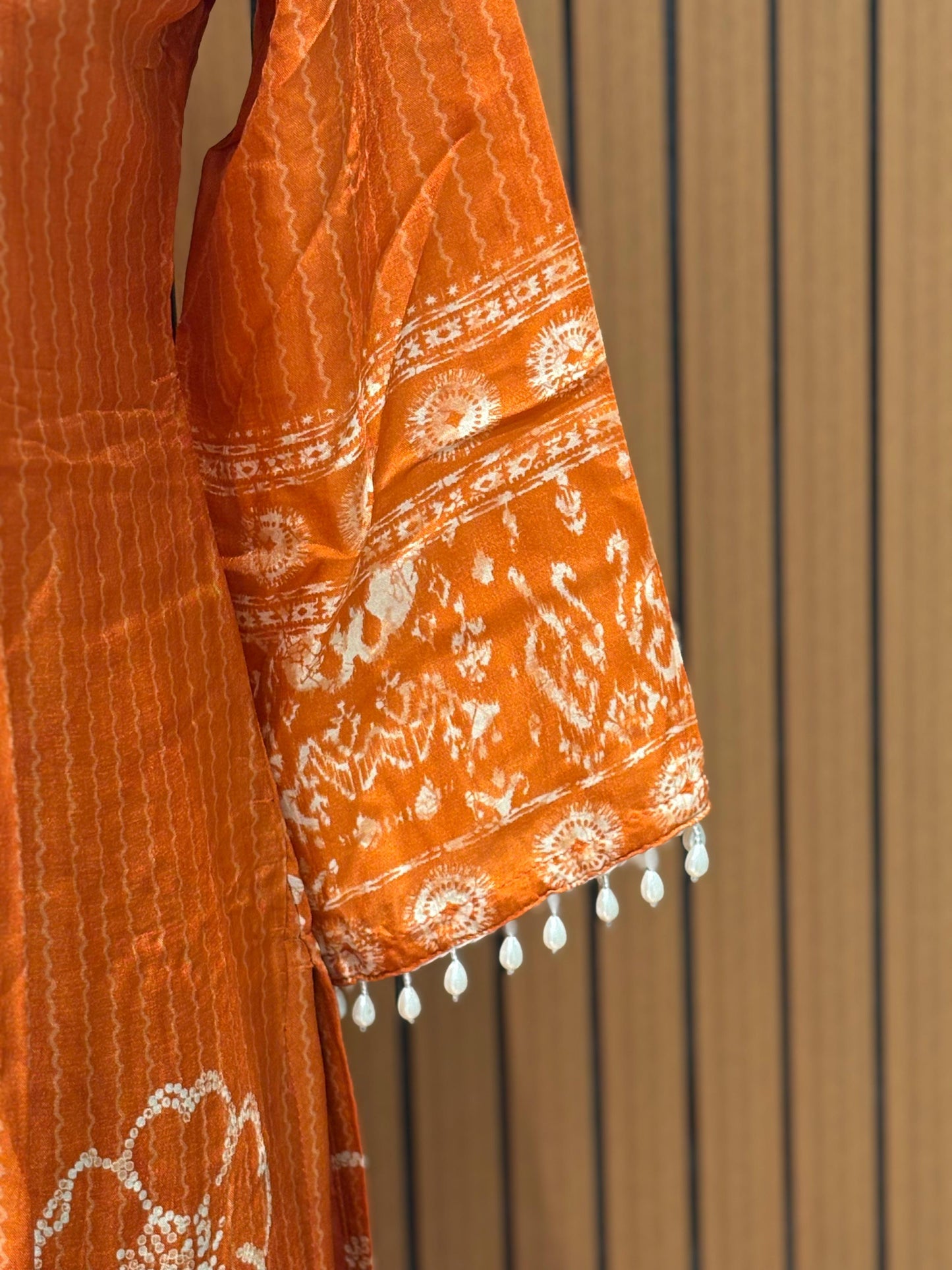 Orange cotton suit with shell mirror work neckline