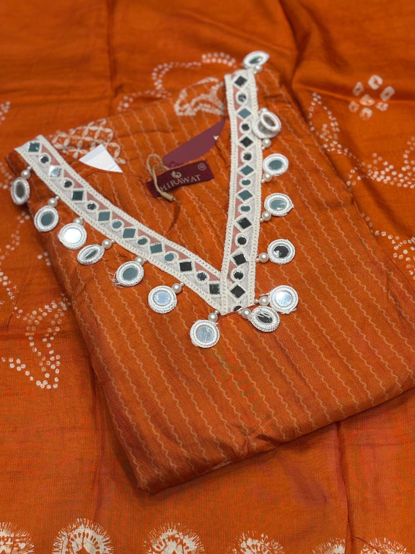 Orange cotton suit with shell mirror work neckline