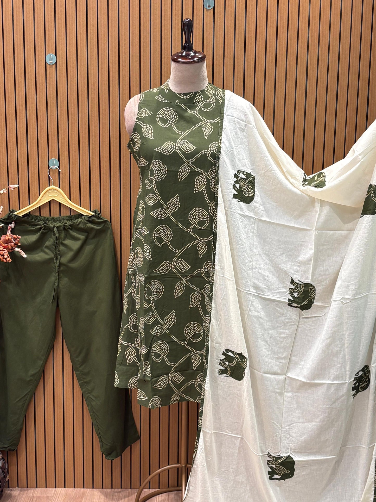 Sleeveless green flared dress with white swirl-leaf