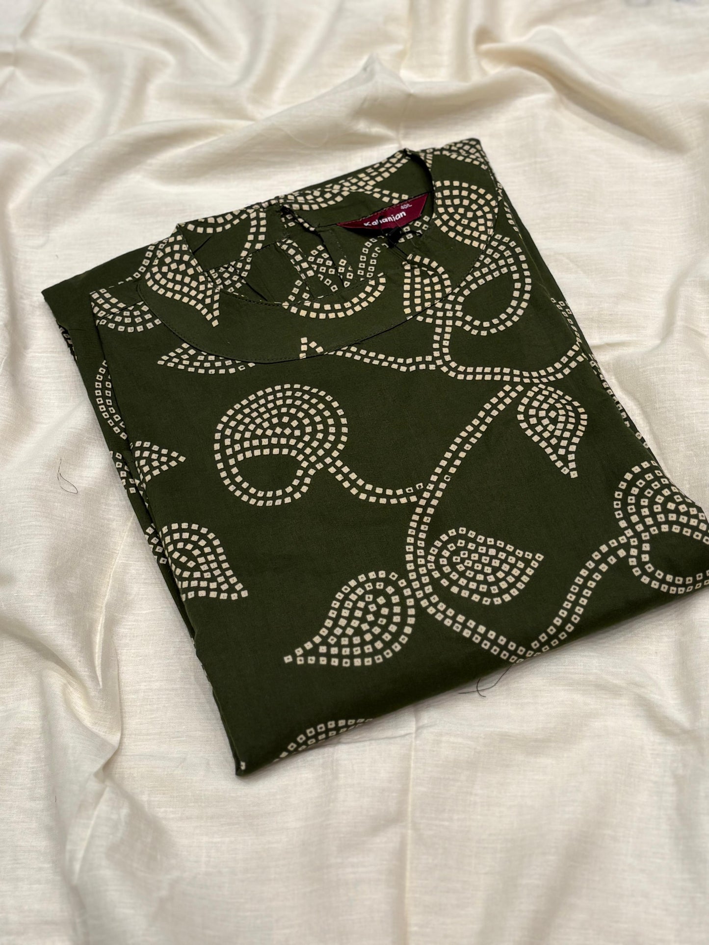 Sleeveless green flared dress with white swirl-leaf