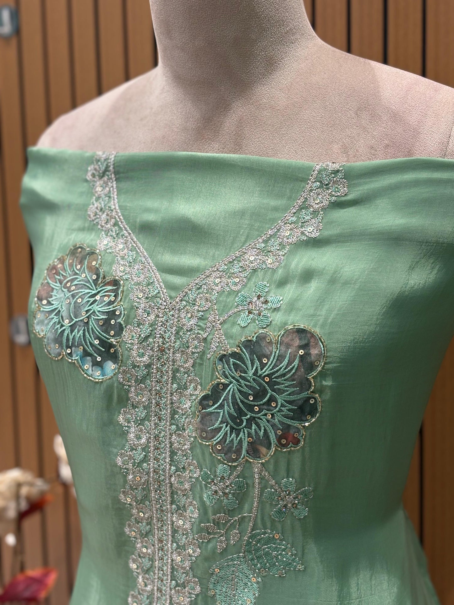 This elegant unstitched suit set features a rich organza fabric