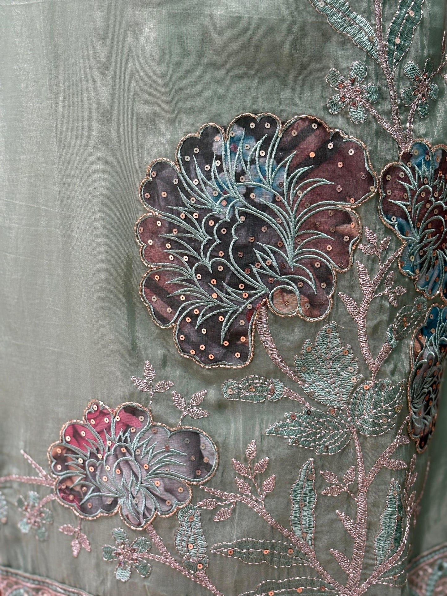 This elegant unstitched suit set features a rich organza fabric