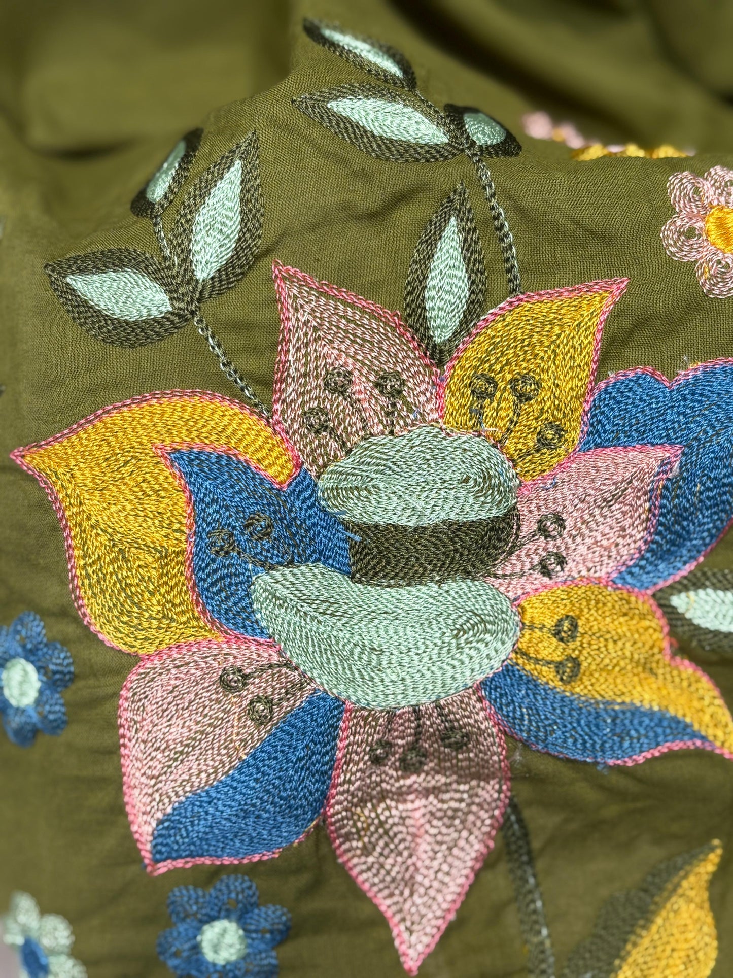 A soft and breathable cotton fabric in a rich olive green shade