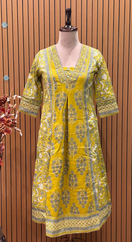 Vibrant yellow Anarkali set in pure cotton features intricate ethnic prints