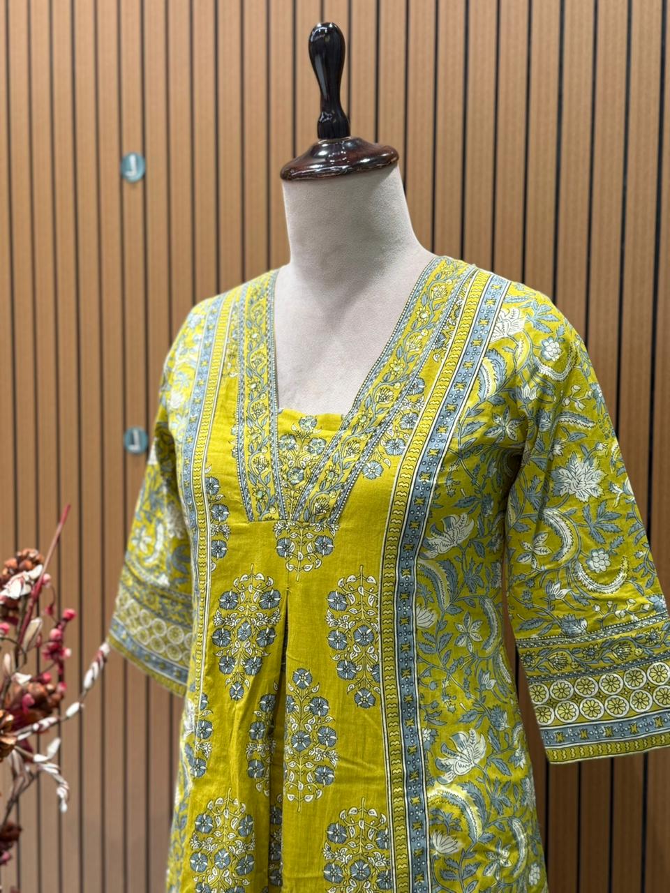 Vibrant yellow Anarkali set in pure cotton features intricate ethnic prints