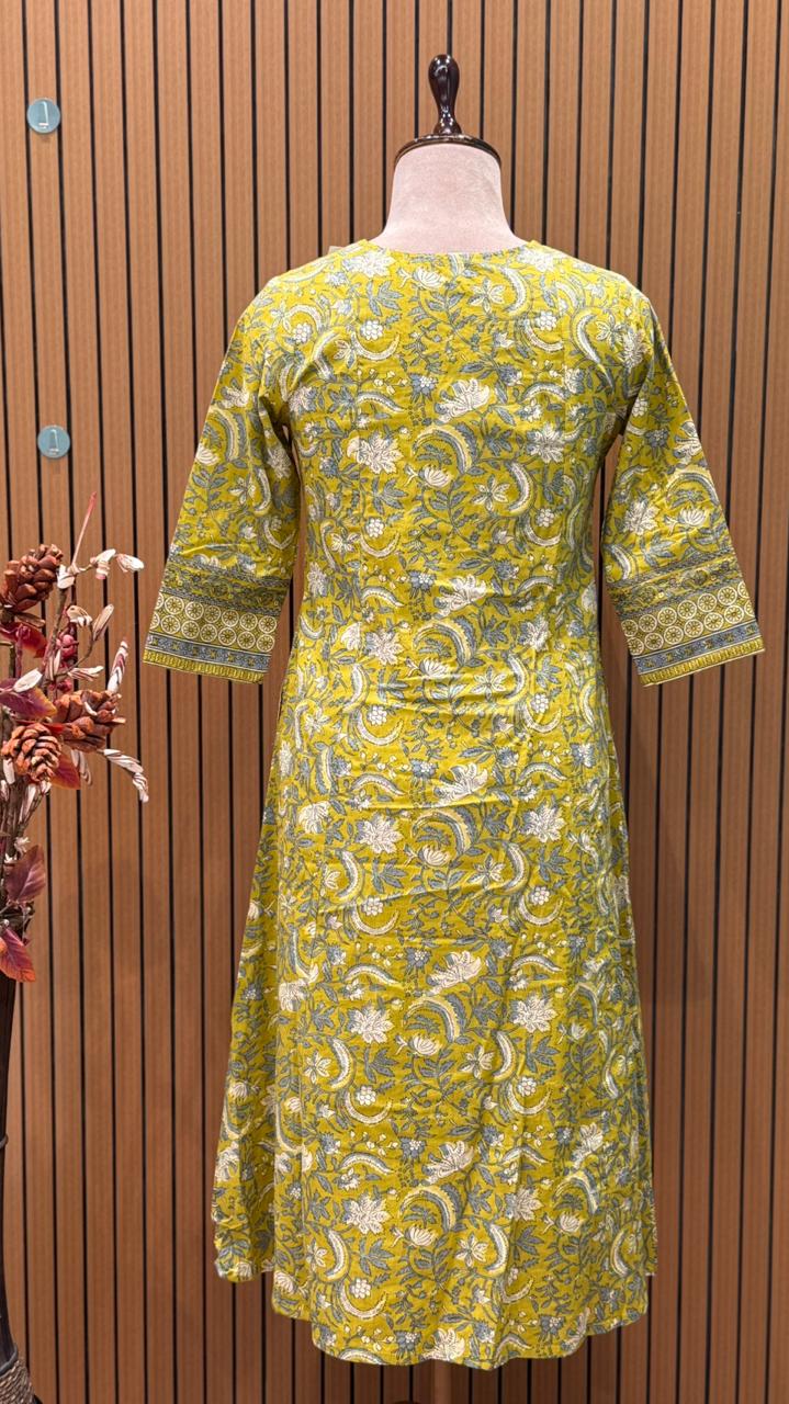 Vibrant yellow Anarkali set in pure cotton features intricate ethnic prints