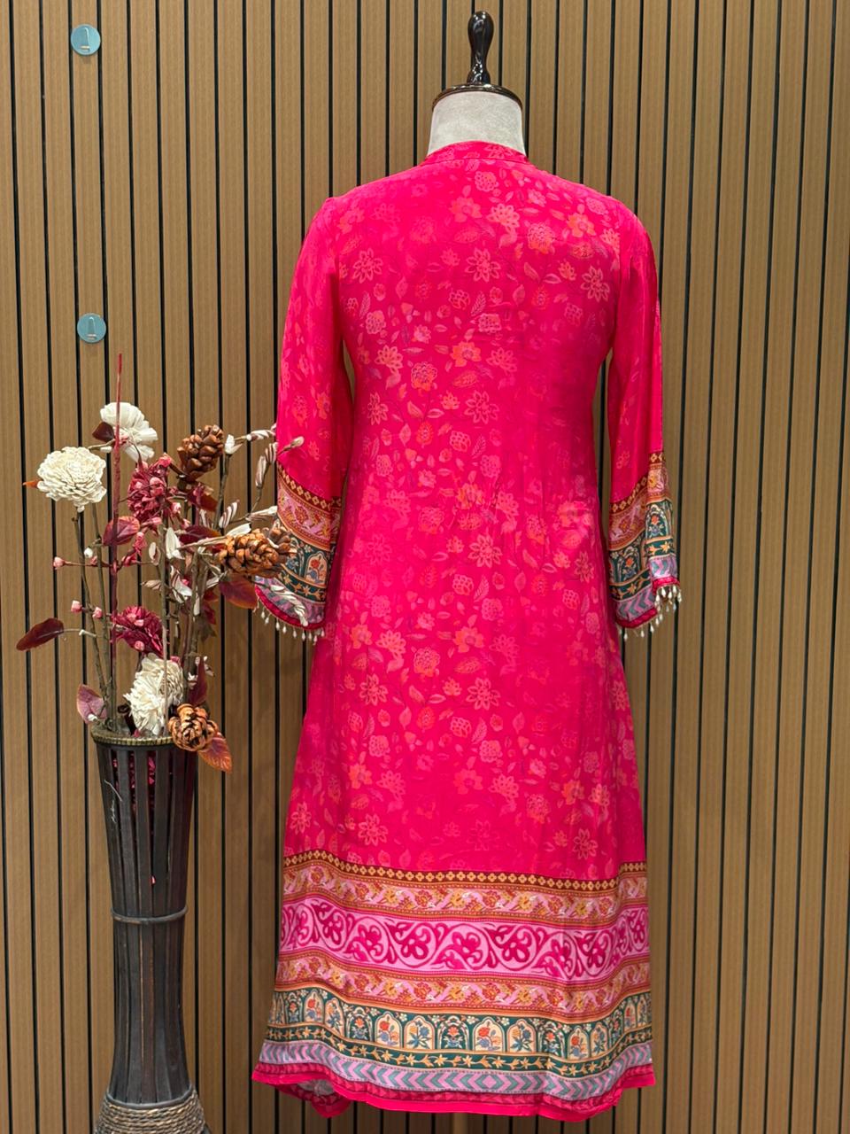 Radiate festive charm in this vibrant pink crape suit set