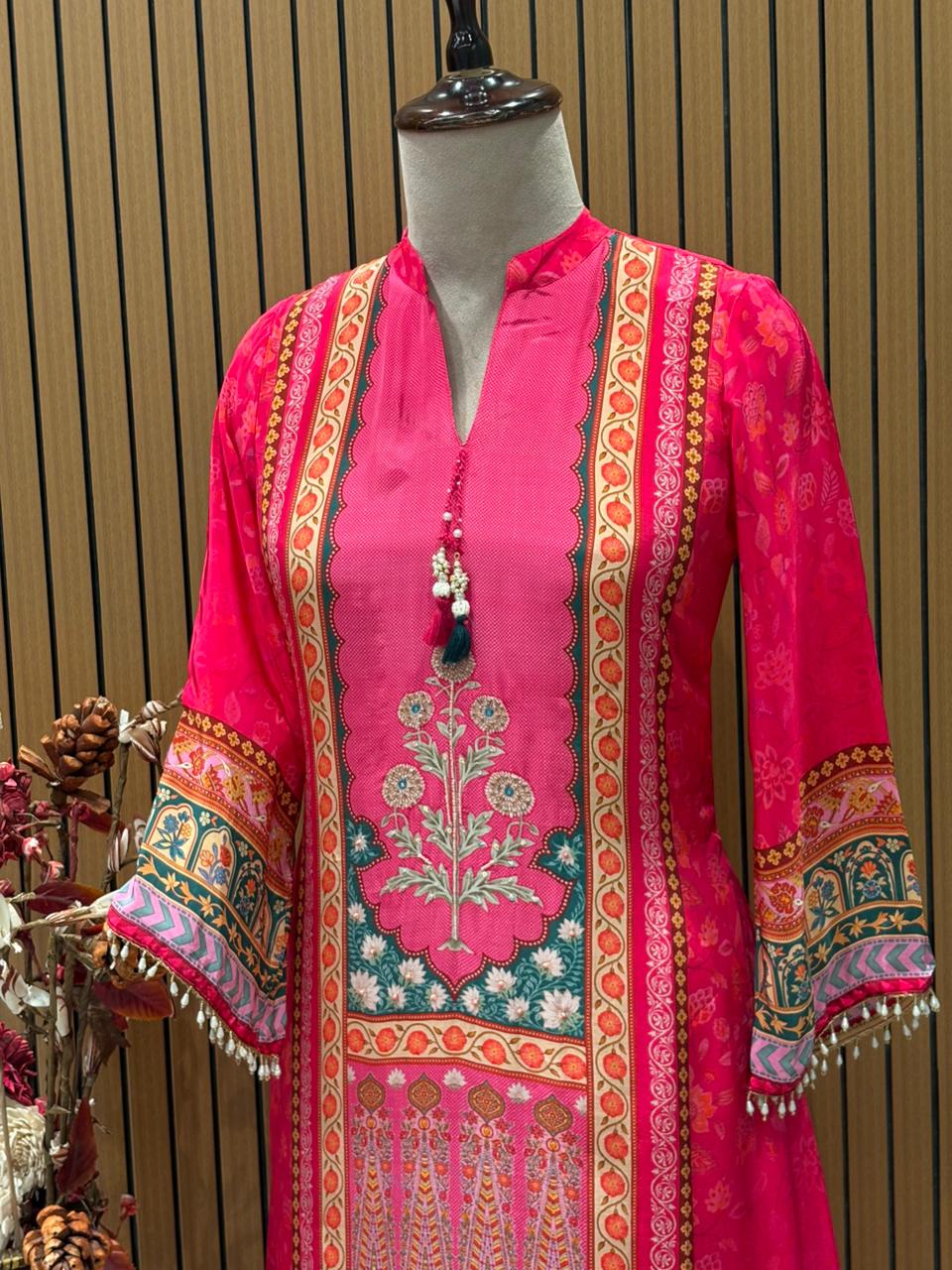 Radiate festive charm in this vibrant pink crape suit set