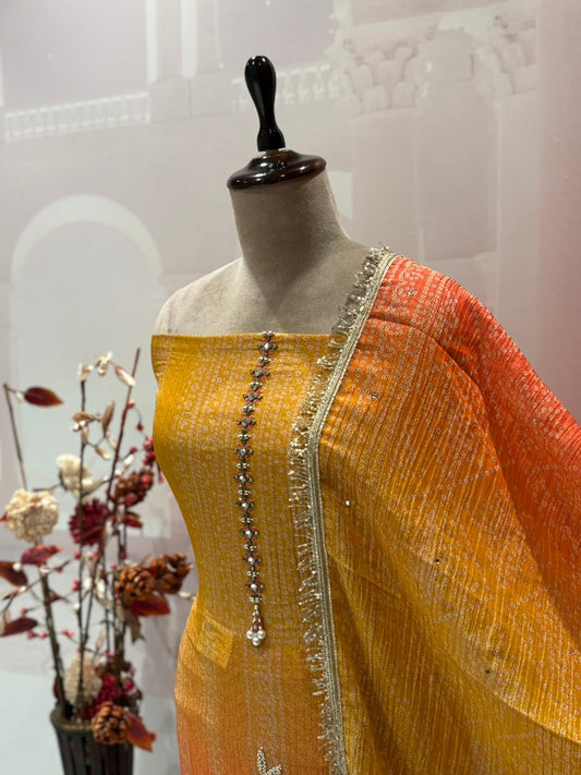 Exquisite unstitched suit set is crafted from premium crush tissue shimmer fabric