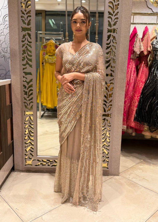 Gold shimmer soft-net saree featuring a stitched blouse