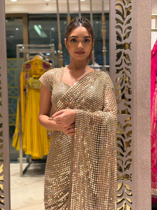 Gold shimmer soft-net saree featuring a stitched blouse