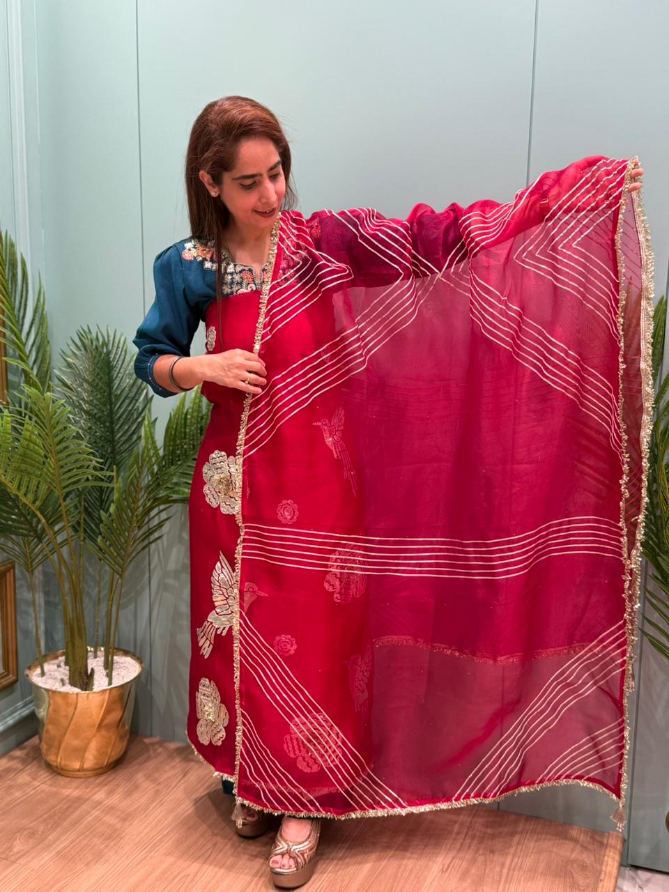 Crafted in organza shimmer fabric with rich gota patch work
