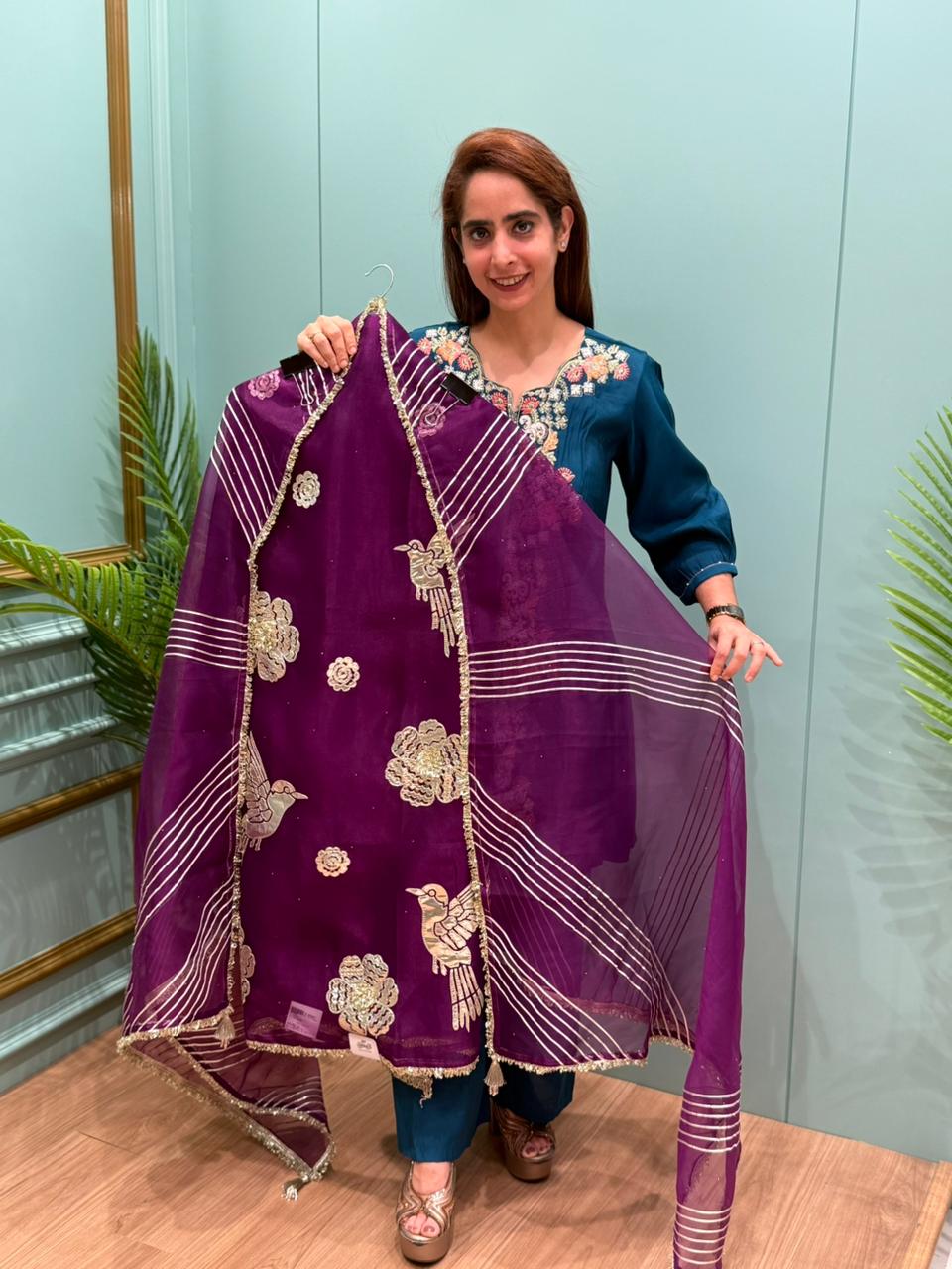 Crafted in organza shimmer fabric with rich gota patch work