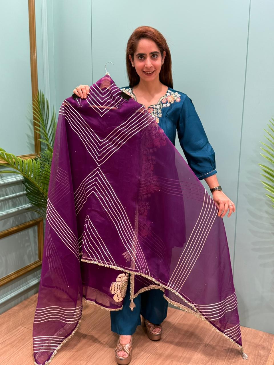 Crafted in organza shimmer fabric with rich gota patch work