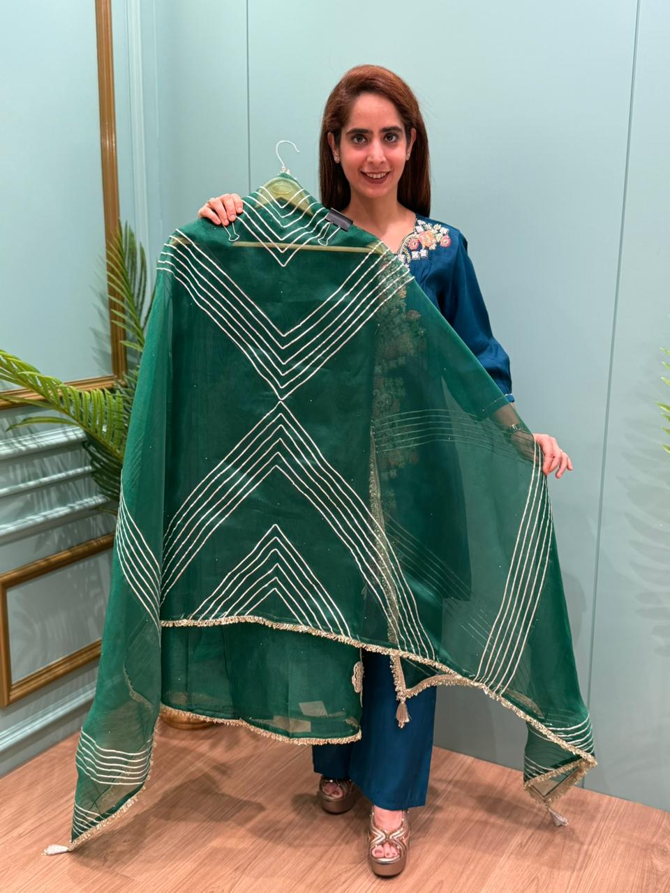 Crafted in organza shimmer fabric with rich gota patch work