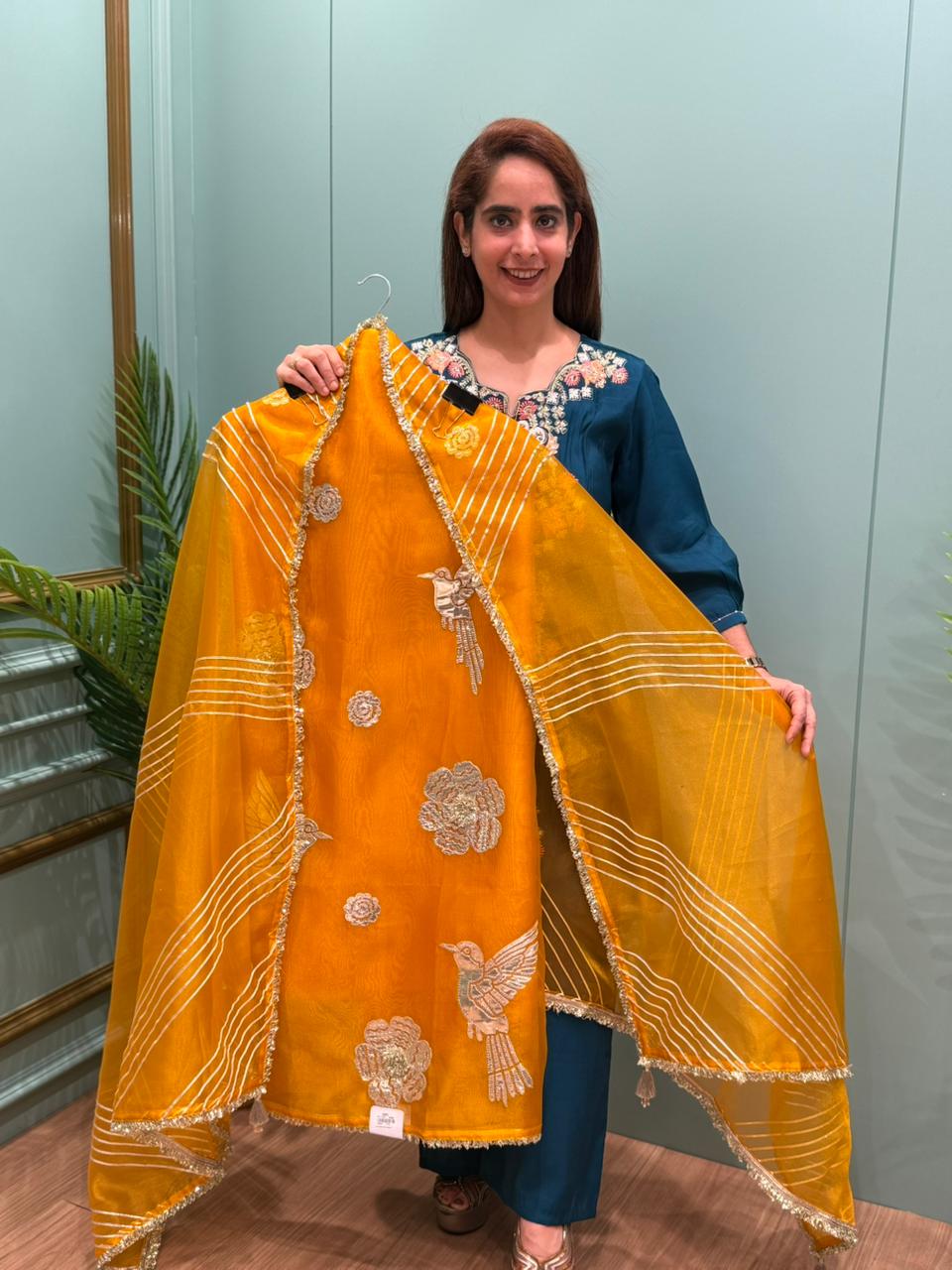 Crafted in organza shimmer fabric with rich gota patch work