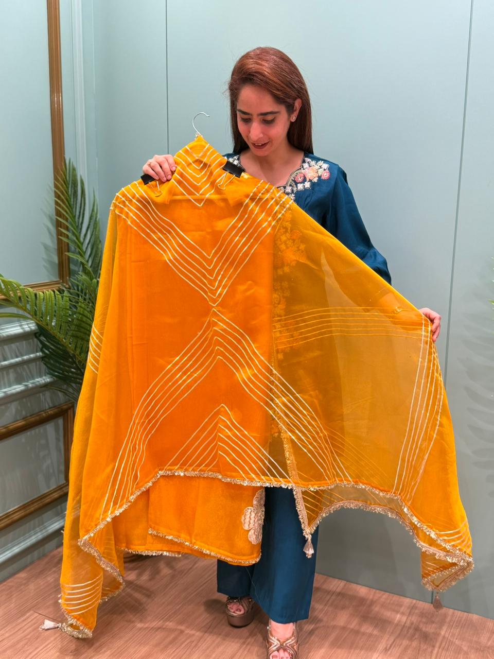 Crafted in organza shimmer fabric with rich gota patch work