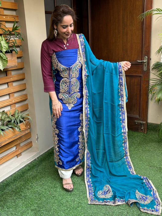 Elegant unstitched suit is crafted in rich silk fabric